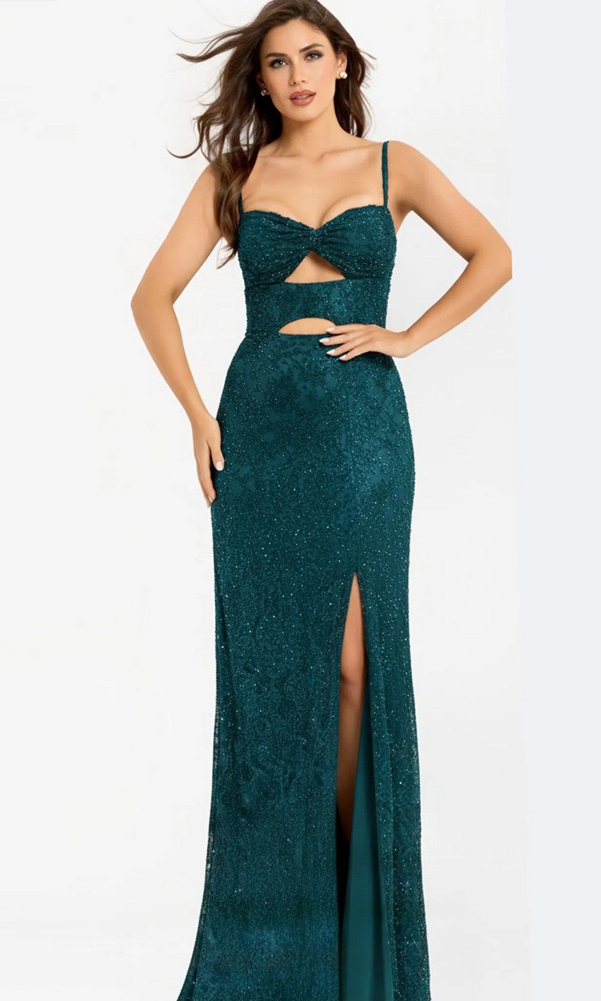 A woman models the Jovani 43764 long prom dress in turquoise, featuring beaded details, a cut-out design, sparkly finish, and a thigh-high slit against a plain light background.